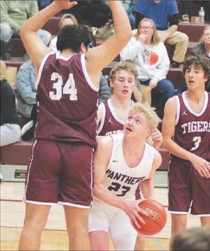Timber Lake’s lone senior, Brady Sandquist (23) looks for a shot while being defended under the basket during recent action against McIntosh. Photo by Jon Flatland