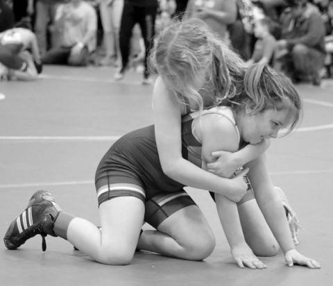 State Qualifier... Timber Lake’s Cassidy Winterberg (bottom) struggles to escape the hold of an opponent during district SDWCA action two weeks ago. Winterberg claimed third place honors in the girls 10-Under 96 division to advance to the SDWCA State Tournament in Rapid City on Friday through Sunday, March 28-30. Photo by Jon Flatland