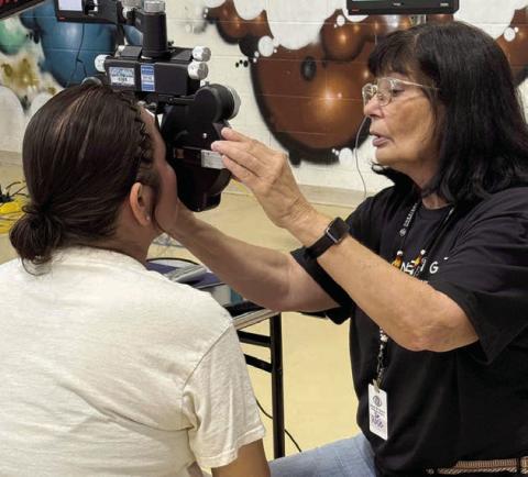 A volunteer optometrist gives an eye exam during a free vision clinic held in Eagle Butte last week. A total of 987 people were served. The event was sponsored by the Cheyenne River Youth Project. Photo by CRYP
