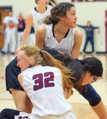 Timber Lake’s Jasmine Nash and Jordan Jones (32) tie up the ball with a Lyman player during their Dec. 28 varsity game in Timber Lake. Photos by Robert Slocum