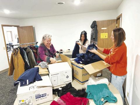 A community drive to make winter coats, jackets, gloves, boots, and other cold-weather clothing available to those who need it got off to a start last week. Here (l-r) Lilian Turcotte, Becky Booth and Kasey Maher sort donations to be displayed. Anyone is welcome to take what they need or drop off new or gently used items of all sizes at The Junction. The room behind the Grounded Coffee Shop will be open Tuesdays through Fridays from 9 a.m. to 4 p.m. until further notice. Photo by Kathy Nelson