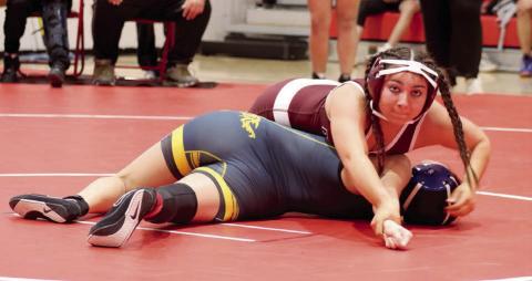 Selena Longbrake (top) bears down while pinning her opponent, Ashley Ghost of Little Wound, in the first round of the C-EB/Dupree Round Robin Wrestling Invitational in Eagle Butte on Monday, Feb. 3. Longbrake, wrestling at 126 pounds, went 3-0 during the event to help the Lady Panthers win second place overall in the team standings. Photo by Jon Flatland
