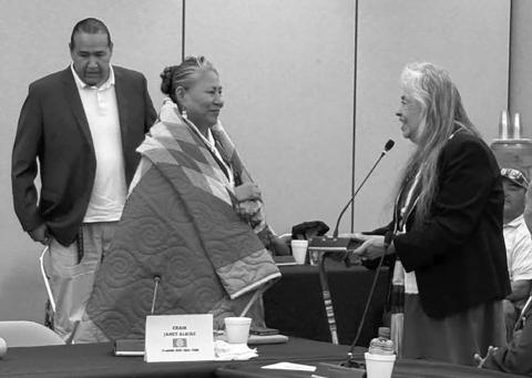 A. Gaye Kingman, (right) executive director of the Great Plains Tribal Chairmen’s Association (GPTCA), presented a star quilt to Janet Alkire, outgoing Chairwoman of the Standing Rock Sioux Tribe, during a GPTCA meeting last week. Looking on is Ryman LeBeau, Chairman of the Cheyenne River Sioux Tribe. Photo courtesy of Great Plains Tribal Chairmen’s Association