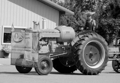 The Best Antique Entry Award at the Timber Lake Days of 1910 Parade went to Kimball and Donna Russell representing CHS River Plains in Isabel with a 1946 Minneapolis Moline tractor. Photo by Jon Flatland