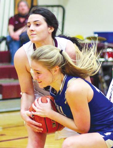 Timber Lake forward Maci Maher (TOP) wrestles an unidentified Wall player for possession of a loose ball during girls hoops action on Friday. Photo by Jon Flatland