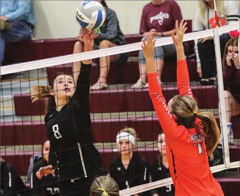 Photo by Robert Slocum Kenna Webb tips the ball over the outstretched arms of Mobridge-Pollock’s Regan Stoick during their game on Sept. 17 in Timber Lake.