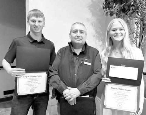 Each year the Cheyenne River Sioux Tribe Telephone Authority presents scholarships to the top two students in the graduating class of each local high school. At the May 6 TLHS awards program, Ken White Eyes of the CRSTTA (middle) presented the salutatorian scholarship to Holden Gill (left) and the valedictorian scholarship to Hailey Roggow (right).