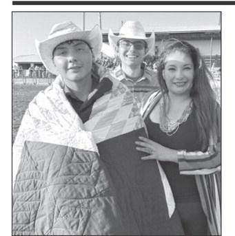White Horse cowboy CJ Jewett, left, was honored by his Aunt Antoinette (Annie) Nicholas and his friend Carl Petersen with a star quilt prior to competing in the ranch bronc riding event at the 3 Rivers Ranch Rodeo on Saturday. Jewett, 18, announced he intends to compete next year in saddle bronc riding on the Professional Rodeo Cowboy Association (PRCA) tour. Photo by Jon Flatland