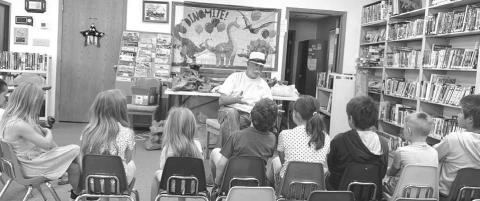 Greg Garon of Timber Lake talked about paleontology at the Dewey County Library’s Summer Reading Program on July 1. The theme of this year’s summer reading program is “Unearth a Story.” Programs continue on July 8, 15, 22 and 29. Attending last week were: Leon Shoots the Enemy, Rhett Aberle, Marie Bad Warrior, Eddie Vogel, Maren Maher, Rowan Maher, Remi Aberle, and Taylor Dupris. Photo by Ann Arnold