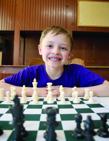 Ben Mareska, 10, took up the game of chess about a year-and-a-half ago after learning how to play the game watching YouTube videos. Today, the Timber Lake Elementary School fourth grader is halfway to becoming a Grand Master, the highest level of player aside from World Champion. Photo by Jon Flatland