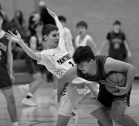 Timber Lake’s Braden Lawrence (left) applies some pressure to a New Underwood ball handler during boys basketball action before the holiday break. Topic photo by Marie DuPreez