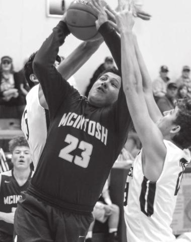 McIntosh’s Charles Taken Alive tries to put up a shot against Timber Lake in the LMC tournament. Taken Alive was an all-tournament selection. Photo by Jon Flatland