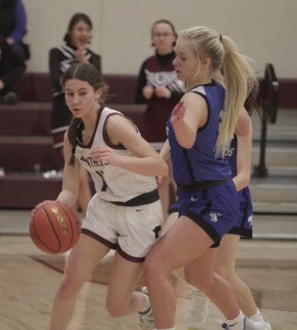 Timber Lake sophomore Natalie Lawrence dribbles past Lemmon defender Allie Kohn (right) during Region 8B tournament action last week. the Lady Panthers advanced to the SoDak 16 with a 66-53 win. Photos by Jon Flatland