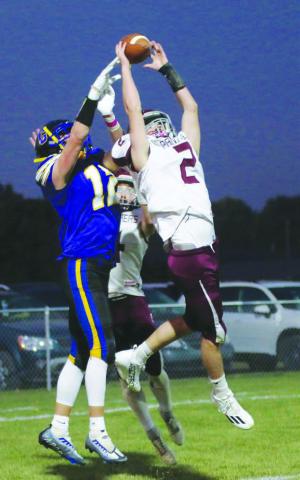 Cole Ducheneaux (2) outleaps Castlewood receiver Jackson Schofield (12) to intercept a pass in the end zone during Timber Lake’s 26-0 loss to the Warriors in the first round of the Class 9A football playoffs last Thursday, Oct. 20. Giving defensive help on the back side is Gracen Hansen. Photo courtesy of LeeAnne Dufek, Hamlin Co. Publishing