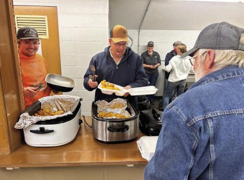 Tye Boldt (left) and Tucker Stocklin share a laugh while dishing up fish and French fries forTim Johnson at the annual Knights of Columbus fish fry at the Isabel Community Center last Friday, March 28.The K of C fish fry moves to Trail City this Friday, April 4, and will be held in Timber Lake on Friday, April 11. (See advertisement on Page 11) Photo by Jon Flatland