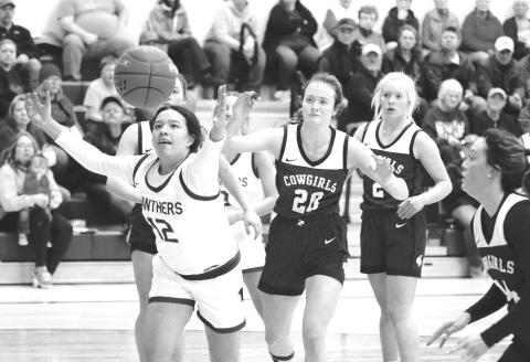 Timber Lake center Kessa Bigger (12) scrambles for a rebound during action against Lemmon last Friday, Dec. 9. Looking on are Lemmon defenders (l-r) Kelly Lynch, Allie Kohn and Emily Faughn. Timber Lake claimed a 59-43 victory to improve to 2-0. Photo by Jon Flatland