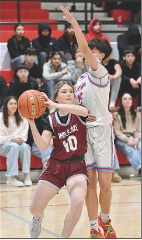 Timber Lake’s Korbi Heck looks to dish the ball along the baseline while being defended by C-EB’s Alisa Eberhard during girls basketball action last week. Both the Panthers and Braves are competing in their respective region tournaments this week. Photo by Marie DuPreez