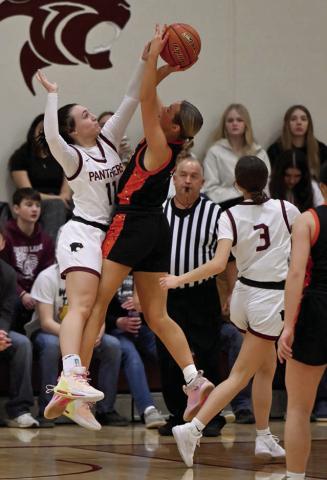 Timber Lake’s Kiya Mowrer (11) blocks a shot attempt by Ipswich guard Brianna Geditz while Natalie Lawrence (3) and the official look on. Photos by Maria DuPreez