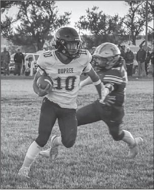 Tre White Wolf (10) spins away from a would-be tackler during Dupree’s 50-28 upset of Harding County/Bison in the first round of the State Class 9A football playoffs. White Wolf rushed for 41 yards and a touchdown in the victory. Photo by Spencer Olsen