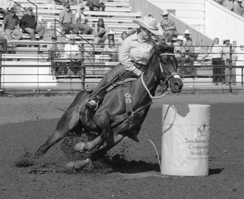 Maddie Gray of Ridgeview leans her horse around a barrel during Saturday morning action in Ft. Pierre.