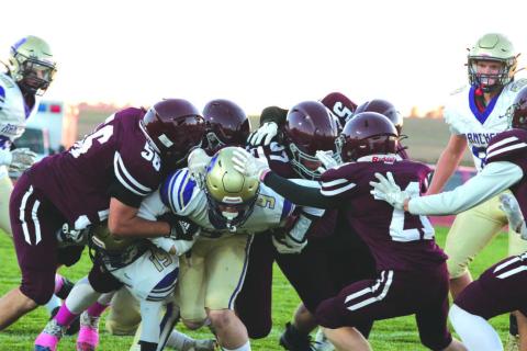 Harding County/Bison running back Rylee Veal, center, proved to be a handful for the Timber Lake Panther defense last Friday. Veal rushed 36 times for 268 yards and scored five touchdowns to lead the No. 5 ranked Ranchers past the Panthers 48-28 to close out the regular season. Combining to bring down Veal on this play were, l-r, Dan Peterson, Mason Arpan, Jack Hornick, Mason Bickel and Eddie Keller. Photo by Jon Flatland