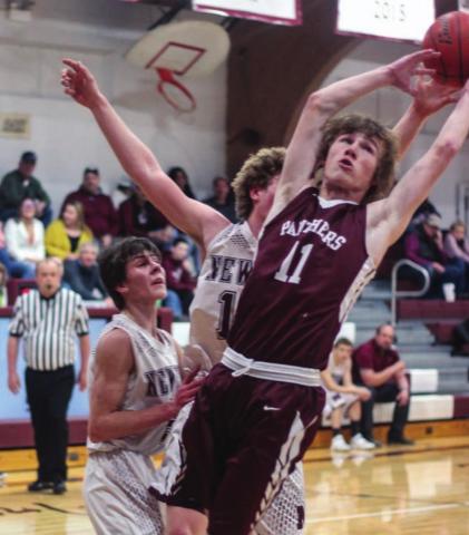 ABOVE: Chase Marshall (11) reaches for a rebound against Newell.