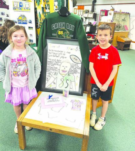 Timber Lake first graders Lakyn Lindskov and Bryson Long were given an assignment to make a poster about a famous person. They chose Green Bay Packers tight end Tucker Kraft. Their poster was first displayed at school and then they loaned it to the Timber Lake Museum for the Tucker Kraft exhibit. Topic photo/Kathy Nelson