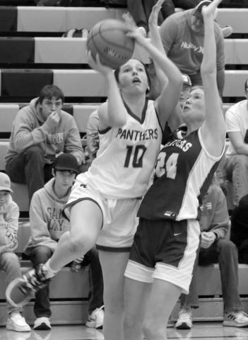 Freshman guard Jaylee Schoelerman draws a foul from Strasburg-Zeeland defender Jordyn Heidrich during action at the Mobridge Rotary Classic on Saturday, Dec. 16. Timber Lake downed the Clippers to improve to 2-3 on the season. Photo by Jon Flatland