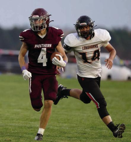 Broc Bauer (4) had a big night last Friday, catching two TD passes and racking up 300 all-purpose yards in Timber Lake’s win over the Faith Longhorns. Photo by Marie Du Preez