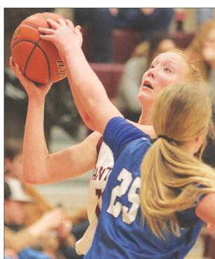 Junior forward Kendyl Locken is fouled by Lemmon’s Madison Dauwen (25) on a drive to the basket during semifinal round action of the 2023 LMC Girls’ Basketball Tournament Friday in Timber Lake. The Cowgirls sank 14 three-pointers to upset the top-seeded No. 3 ranked Lady Panthers 79-54. Photo by Jon Flatland