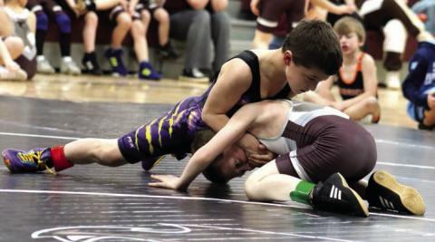 Rowdy Schrempp of Dupree (top) presses a hold on Lincoln Aberle of Timber Lake during recent youth wrestling triangular action. Schrempp will compete in the SDWCA State Wrestling Tournament this weekend in Rapid City. Photo by Jon Flatland