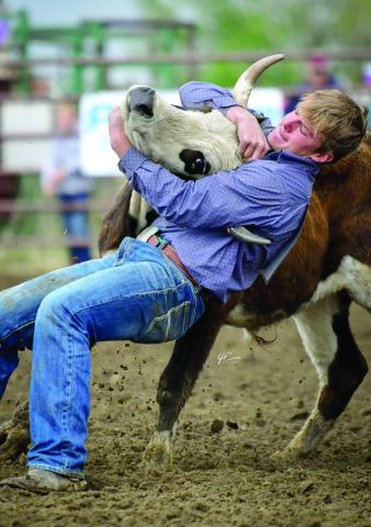 Braydon Terveen-Smith of Lantry takes down a steer during the Dewey County 4-H Rodeo on Sunday, May 25 in Timber Lake. He won the senior boys steer wrestling, senior boys saddle bronc riding, and teamed with Rylee Price of Faith to win the team roping event. All of that earned Terveen-Smith the senior boys All-Around honors. Photo courtesy of Chuck Miner