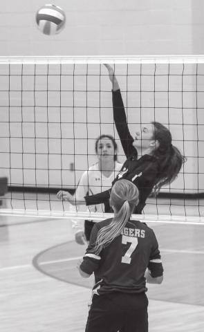 LEFT: Sara Holzer sends a spike over the net. Holzer has been contributing at the net for Timber Lake as the season has gone on. Photos by Jon Flatland