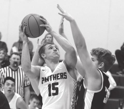 Timber Lake senior Hank Kraft powers to the hoop during home varsity basketball play versus North Central Photo by Jon Flatland