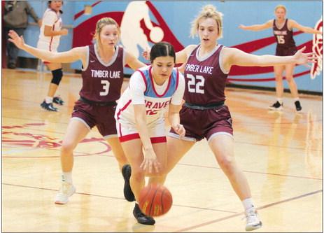 Timber Lake’s Carlie Lawrence (3) and McKenzi Vomacka (22) pressure Cheyenne-Eagle Butte’s Tiana Johnson during the Lady Panthers 56-30 win over the Lady Braves last Friday, Feb. 17, in Eagle Butte. Timber Lake closed its regular season at 14-5 and is the No. 1 seed in the Region 8B Tournament. Photo by Jon Flatland