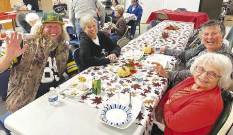 Nick Johnson (left) with a table of new-found friends at the Timber Lake Museum potluck dinner on Sunday (l-r) Johny Weber, Judy Garon and Patty Kjellsen.