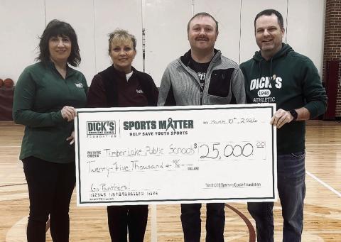 The Timber Lake School District was recently awarded a $25,000 donation from the DICK’s Sporting Goods Foundation to be used for purchasing wrestling mats and upgrading volleyball equipment. Pictured (l-r) are TLHS alum Randi Aberle, Supt. Lori Enright, wrestling coach Sawyer Sandquist, and Michael Shaughnessy, manager of DICK’s Sporting Goods in Bismarck, ND.