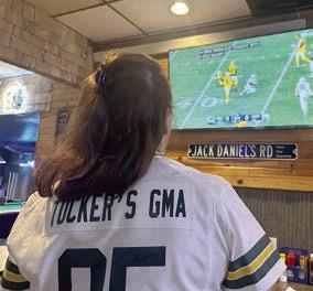 Linda Kraft, Tucker Kraft’s grandmother, watches him on the television at The Corner Bar &amp; Grill.