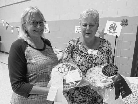 Diana Aberle (left) baked the reserve champion pie at the Dewey County Fair, and Dawn Leibel won the grand champion ribbon and cash award for her pie and reserve champion for her cookies.