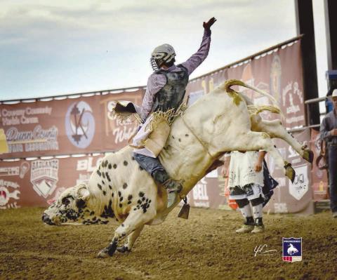 Bear Creek bull rider Stran Smith has been turning in some strong performances on the county fair rodeo circuit so far this summer, finishing in the money at events in Ellendale, ND, and Fertile, MN, last seekend. Smith scored 64 points on a Bailey Pro Rodeo bull named Charlie Sheen to claim second place at the Dickey County Fair and posted a 77 point effort on NorEaster from Triple R Rodeo to finish third overall at the Polk County Fair. Photo courtesy of Chuck Miner
