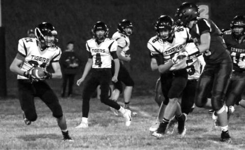 Dupree senior Cinch Hebb (21) runs with the ball against the Lemmon/McIntosh Cowboys on Friday in McIntosh as teammates Treg Thorstensn (4) and Tyler Stambach (8) look on.
