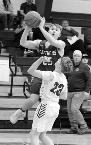 Timber Lake sophomore Gabe Keller (25) goes over a Lemmon defender for a layup during Little Moreau Conference boys basketball action earlier this season. Keller is one of seven sophomores and seven juniors expected to return to the court for Timber Lake next winter. Photo by Jon Flatland