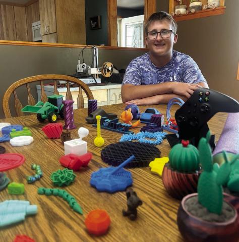 Self-taught toy manufacturer Evan Schweitzer, 16, shows off just a few of the 100-or-so fidget spinner designs he has made and currently offers for sale. Fidget spinners - popular about 10 years ago, are making a comeback, he says, not just as toys but to help those with ADHD, anxiety, autism and more. Photo by Jon Flatland