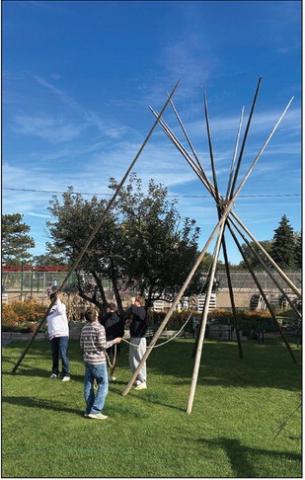 At the end of the day, high school boys learned how to take down the tipi, which groups of students had visited throughout the day. Photos by Kathy Nelson