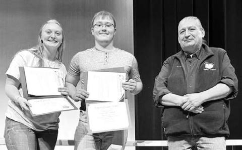 Cheyenne River Sioux Tribe Telephone Authority presented scholarships to Timber Lake High School seniors at Awards Day on May 7. Ken White Eyes, Asst. General Manager, presented the awards. Above: Co-valedictorians Jordan Jones (left) and Gabe Keller received $250 scholarships.