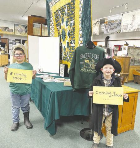 Blane and Brady Biegler and their mom, Kaleigh, are putting together a Tucker Kraft/Green Bay Packers exhibit at the Timber Lake Museum, which will be finished soon. Photo by Kathy Nelson
