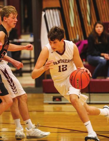 Timber Lake starter Dixon Booth dribbles to the hoop during a home contest versus Faith. Photos by Robert Slocum
