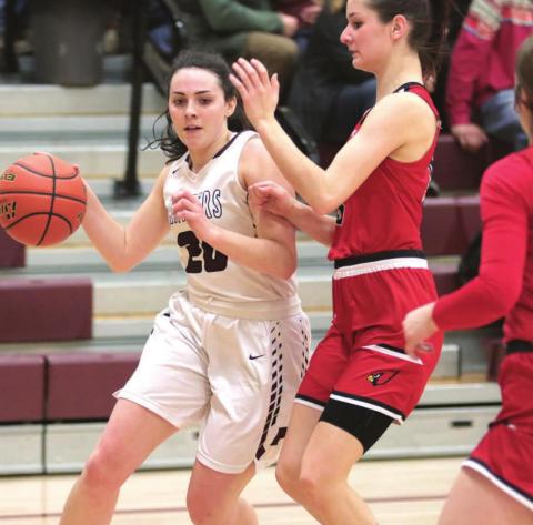 Timber Lake senior Maci Maher tries to dribble past Bison’s Alexia Donavan during their Region 8B playoff game last week in Timber Lake. The Cardinals shocked the favored Panthers and advanced to the SoDak 16 round. Photo by Jon Flatland