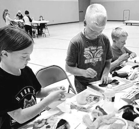 (L-R): Zoey Spiel, Eli Zeug and Isaac Zeug work patiently on their needle felting projects.
