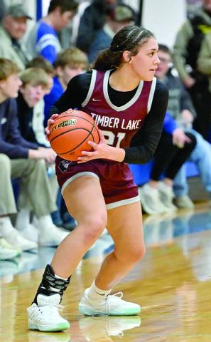 Timber Lake forward Jasmine Nash surveys the floor before running the Lady Panthers offense during recent girls basketball action. Nash, a senior, dropped a team-high 16 points to lift Timber Lake past Herreid– Selby before the holiday break and improve to 2-2 overall. Topic photo by Marie Du Preez